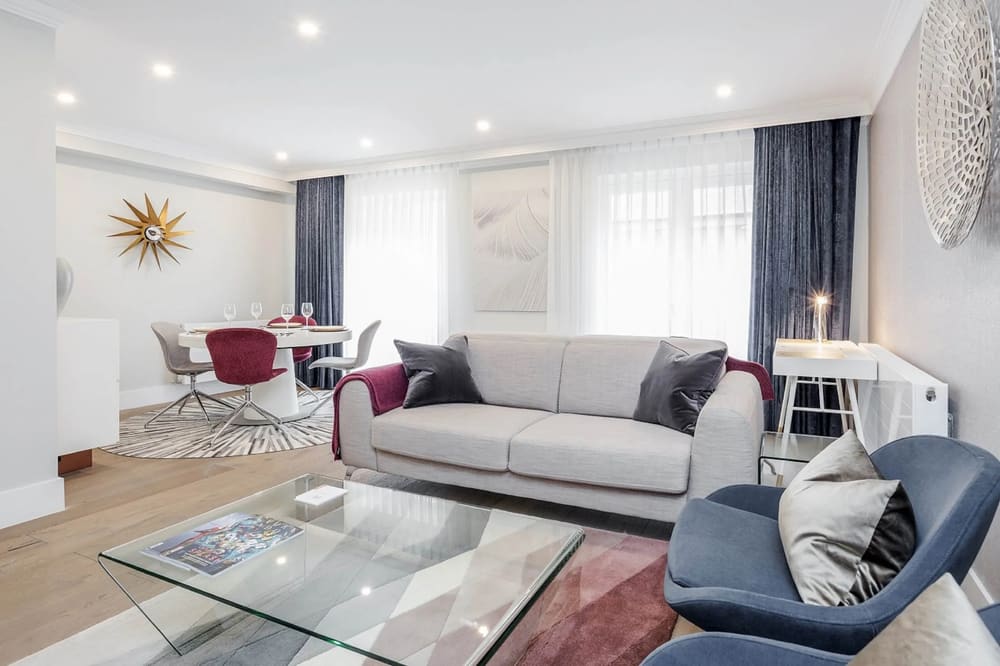 Mayfair Mews Apartment I, Mayfair: Living room with grey sofa and dining area beyond