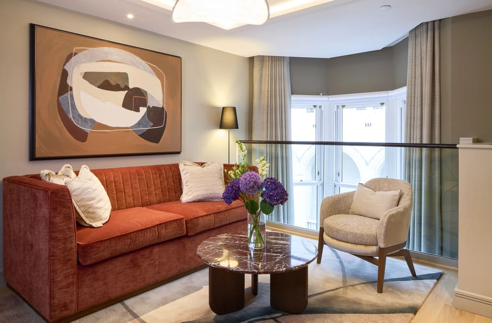 Cheval Phoenix House, Chelsea: Living room with terracotta sofa and bay window