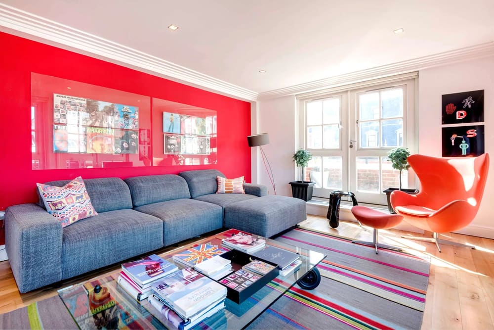 Covent Garden 3 bedroom, Covent Garden: Living room with red feature wall and grey sofa