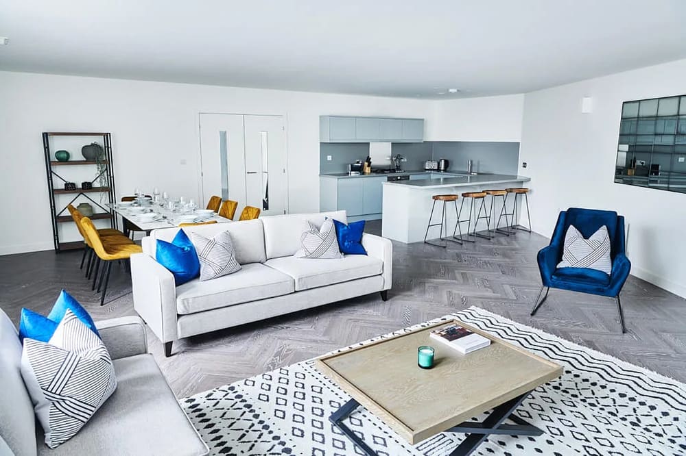 The Shoreditch Warehouse Apartments, East London: Open-plan living room with kitchen and patterned rug