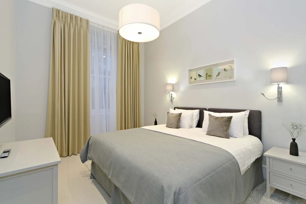 Queensgate Court, Kensington: Double bedroom with drum pendant light