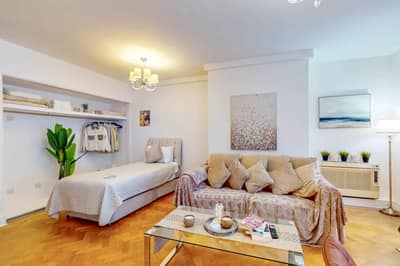 Mayfair Collection, 37 Clarges Street, Mayfair: Living room with pale sofa and armchair