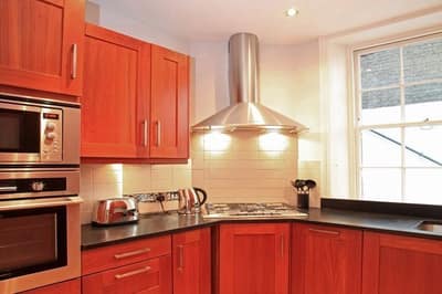 Abingdon Mansions, Kensington: Kitchen with red cabinets and fitted appliances