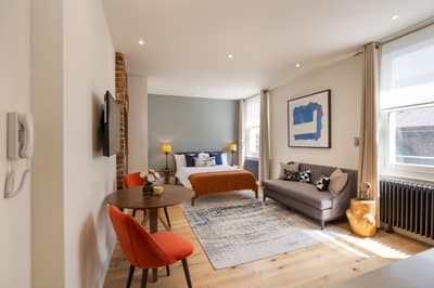 The Armitage Notting Hill, Notting Hill: Living space with grey sofa and red chair