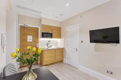 Cleveland Residences Kensington, Earl's Court: Studio with dining table beside kitchen