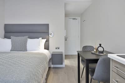 Cleveland Residences Paddington, Paddington: Studio bedroom with upholstered bed and armchair