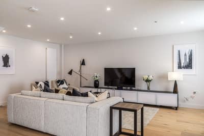 Hazlitt Mews Four Bedroom House, Kensington: Living area with pale sofa and wall-mounted television