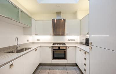 Kinnerton Street Three Bedroom House, Belgravia: Kitchen with pale cabinets and fitted oven