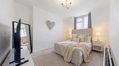 Marloes Road Two Bedroom Apartment, Kensington: Bedroom with white bedding and bedside lamps