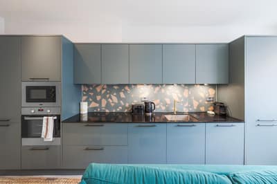 Noxley Newington Green One Bedroom, East London: Kitchen cabinets with patterned tiled splashback