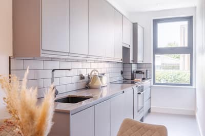 Noxley West Kensington Two Bedroom, Fulham: Kitchen counter with kettle beside a window
