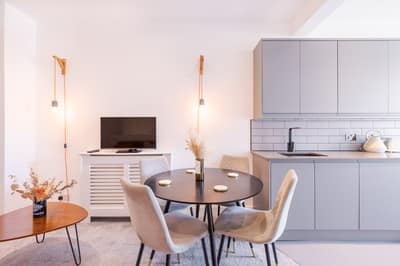 Noxley West Kensington Two Bedroom, Fulham: Dining area with pendant lights and white chairs