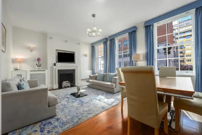 Tavistock Place Apartments, Bloomsbury: Living room with corner sofa and artwork
