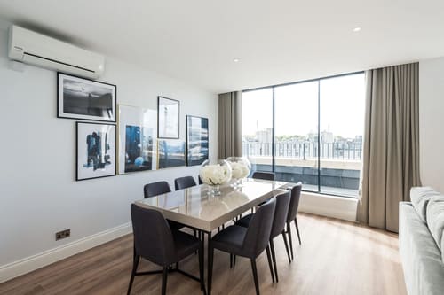 The Carlyle Apartments, Earl's Court: Dining table by full-width windows