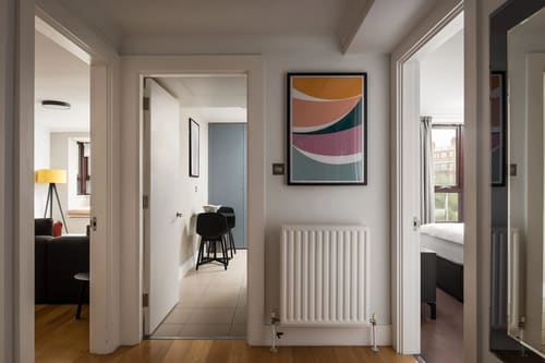 The Monarch Apartments, Kensington: Hallway with radiator and abstract print