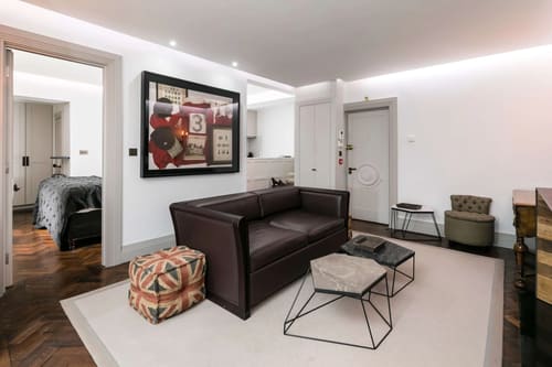 Prime Mayfair 1 bedroom no.4, W1K, Mayfair: Living room with leather sofa and framed artwork