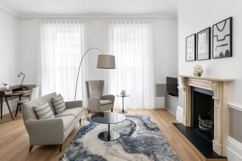 The Hertford Street Apartments, W1J, Mayfair: Living room with fireplace and marble-effect rug