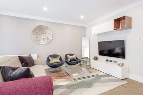 Mayfair Mews Apartment I, Mayfair: Living room with swivel chairs and wall-mounted TV