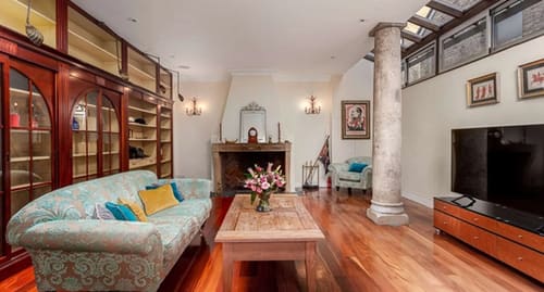 Notting Hill 3 bedroom near Ladbroke Grove, Notting Hill: Living room with fireplace, column and bookshelves