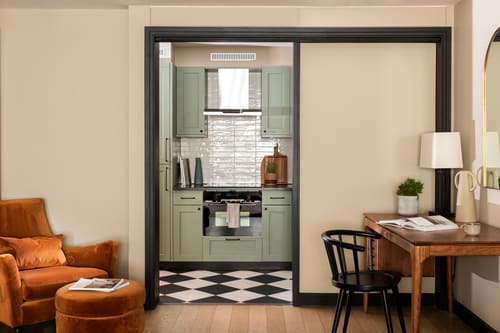 The St Paul’s Apartments, East London: Sage green kitchen with chequered floor