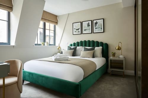 Chancery Lane Apartments, Holborn: Bedroom with green scalloped headboard