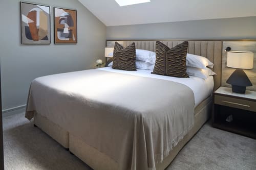 Cheval Phoenix House, Chelsea: Double bedroom with grey upholstered headboard
