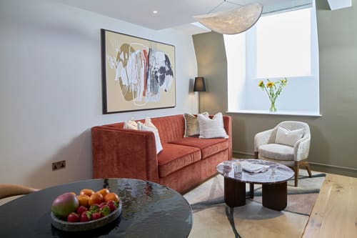 Cheval Phoenix House, Chelsea: Living room with terracotta sofa and marble coffee table