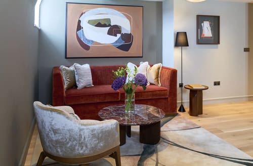 Cheval Phoenix House, Chelsea: Terracotta sofa with abstract painting above