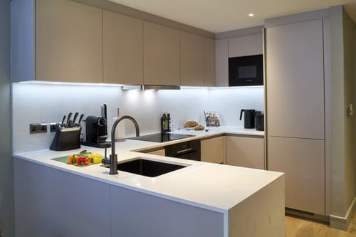 Cheval Phoenix House, Chelsea: Kitchen with taupe units and white worktop