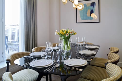 Cheval Harrington Court, Kensington: Dining table laid with tulips and glassware