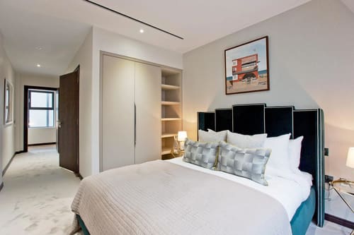 The Golden Square Apartments, West End: Double bedroom with tall headboard and shelving