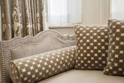The Sloane Club Apartments, Chelsea: Studded headboard with patterned cushions