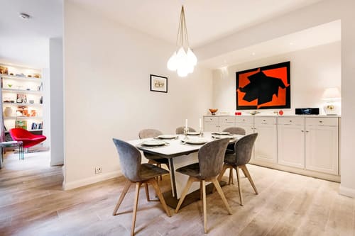 Secluded 2 bedroom Belgravia House, Chelsea: Dining table with grey chairs and red artwork