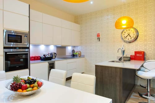 Colonnade, Bloomsbury: Kitchen with island and orange pendant lights