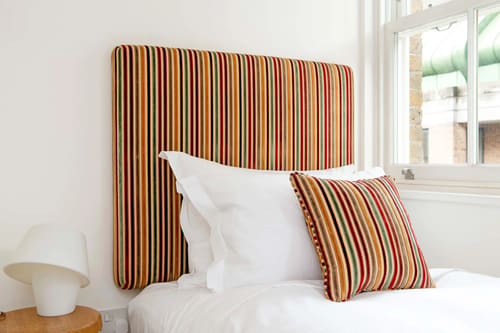 Colonnade, Bloomsbury: Bed with striped upholstered headboard