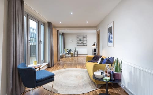 Waterloo Apartments, Waterloo: Long living room with mustard sofa