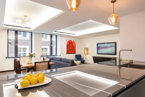 The Golden Square Apartments, West End: Open-plan kitchen and living room with pendant lights