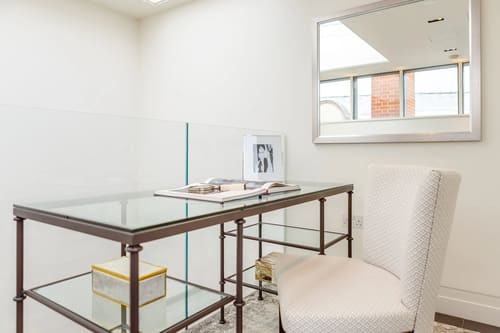 Green Street, W1K, Mayfair: Glass and brass desk under a skylight