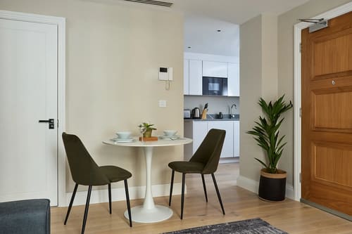 Chancery Lane Apartments, Holborn: Bistro table with two chairs and kitchen beyond