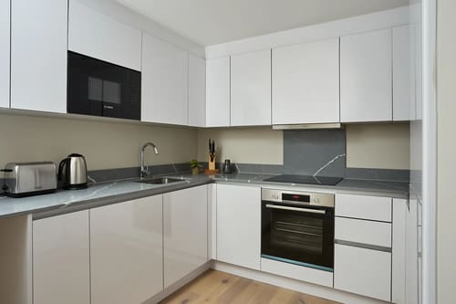 Chancery Lane Apartments, Holborn: Kitchen with white units and grey worktop