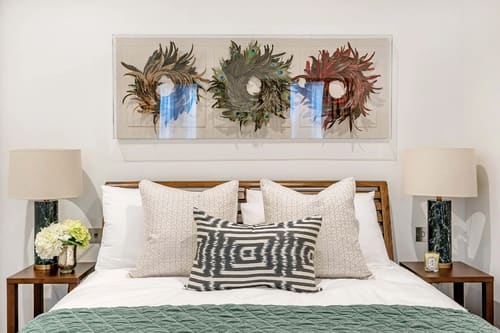 Hyde Park Gate Residences, Kensington: Bed with patterned cushions beneath dried-flower art