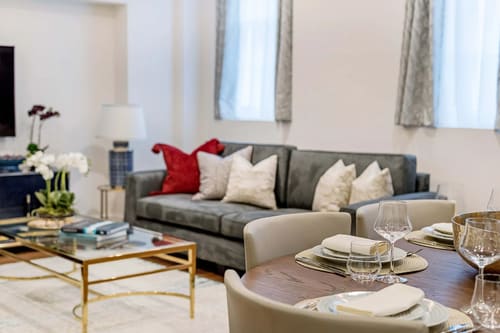 Hyde Park Gate Residences, Kensington: Grey sofa with red cushions and coffee table
