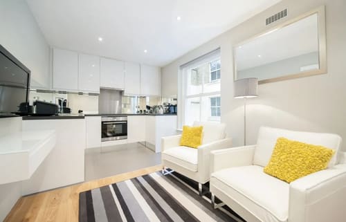 Three Harrington Gardens, Kensington: Studio with white armchairs and kitchen