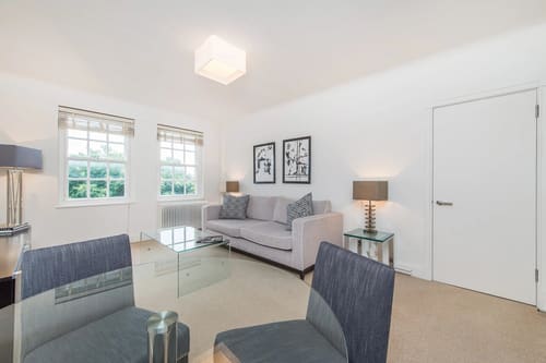 Chelsea Mansion Block, Chelsea: Living room with grey sofa and glass coffee table