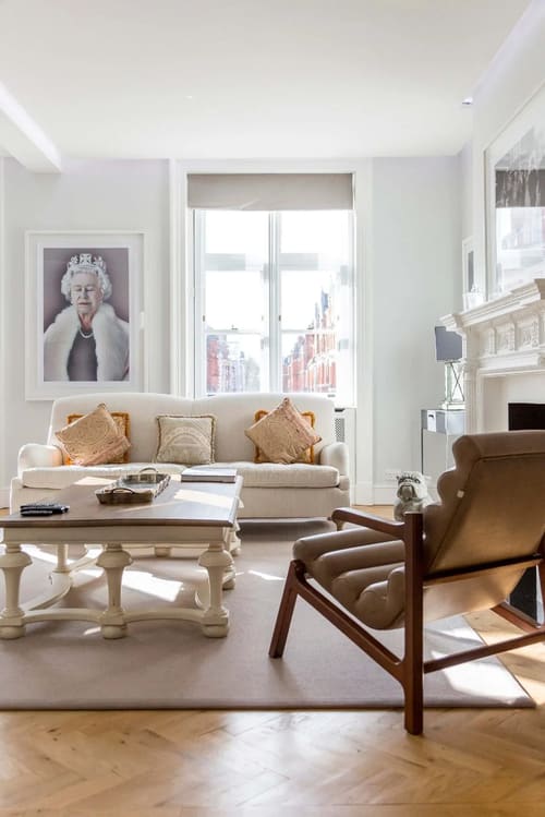Prime Mayfair 3 bedroom Apartment, Mayfair: Sitting room with cream sofa and leather chair