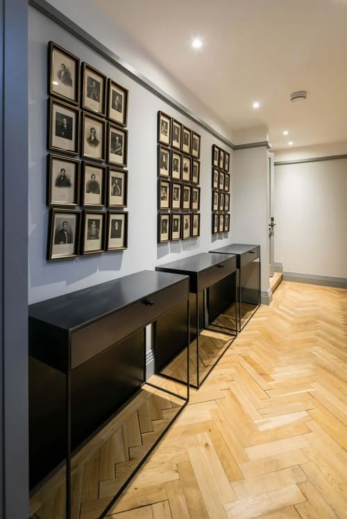 Prime Mayfair 1 bedroom no.3, W1K, Mayfair: Hallway lined with framed portraits