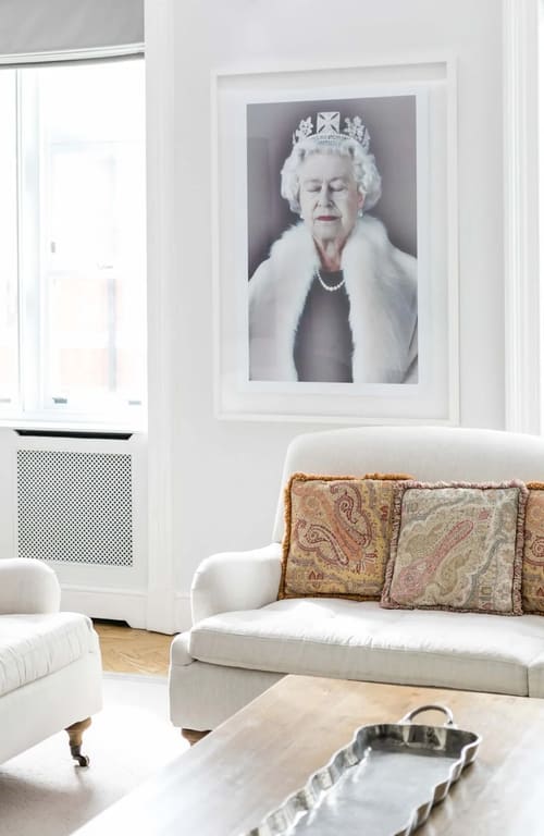 Prime Mayfair 3 bedroom Apartment, Mayfair: Armchair with paisley cushion beneath a portrait print