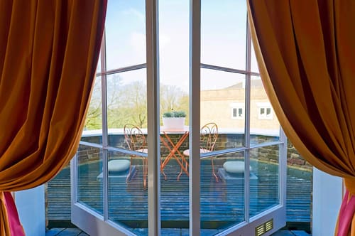 Craven House, Hampton Court: Balcony with bistro table seen through tall windows