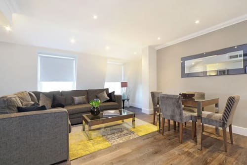 Ashburn Court, Kensington, Kensington: Living room with grey sofa and recessed ceiling lights