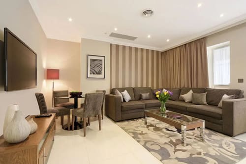 Ashburn Court, Kensington, Kensington: Living room with corner sofa and striped feature wall